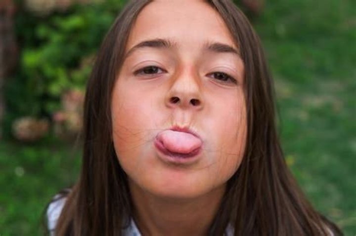 What does it mean when a girl sticks out her tongue